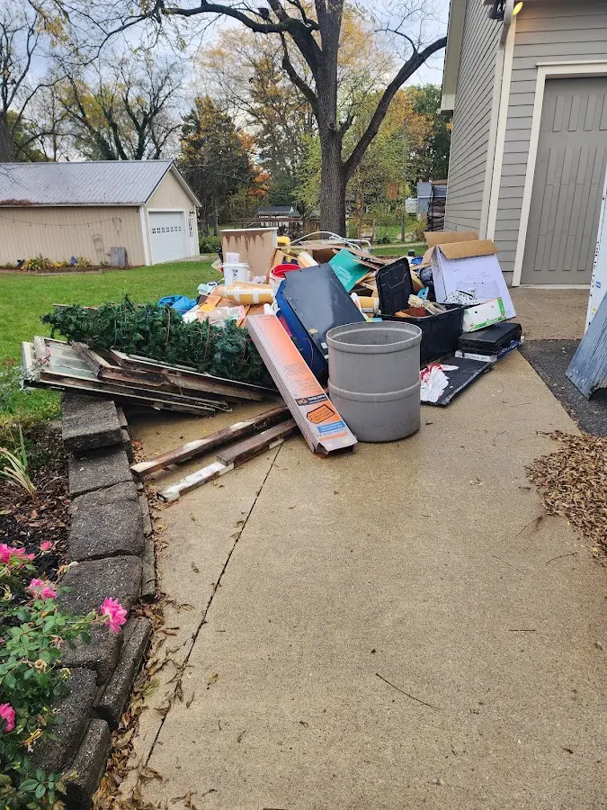 Dumpster being loaded with debris for Estate Cleanout Dumpster Rental in Two Rivers